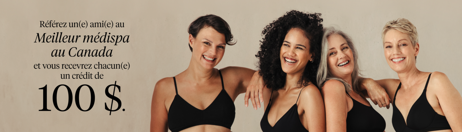 Women smiling together wearing black underwear. Refer a friend to the best Medispa in Canada: Victoria Park Medispa and receive a $100 giftcard.